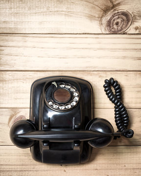 Old telephone on wood background., Flat lay with copy space.