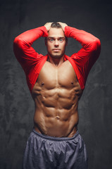 Abdominal bodybuilder model in a red jersey.