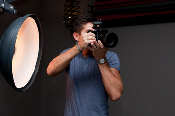 photographer with a medium format camera in the studio