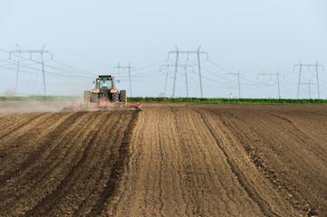Tractor preparing land