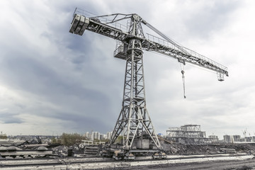 Building crane at the abandoned construction site