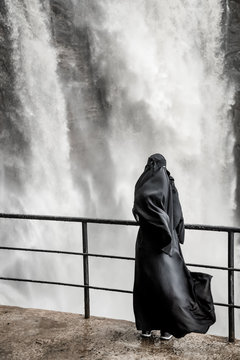 Woman is standing near waterfall. Shri-lanka