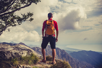 Hiking man or trail runner in inspiring mountains