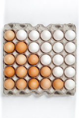 white and brown eggs lying in lattice in order