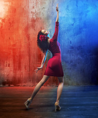 Attractive brunette beauty in a dance pose