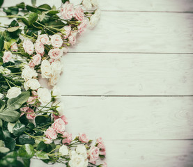 Delicate fresh roses on the white wooden background. Vintage sty