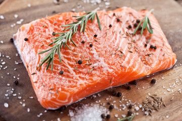 Salmon filet on a wooden carving board.