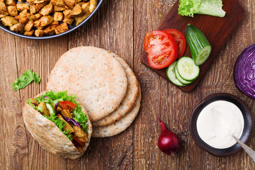 Pita salad with roasted chicken and vegetables, served with a de