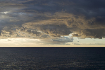 Dark cumulus clouds hovering over the sea