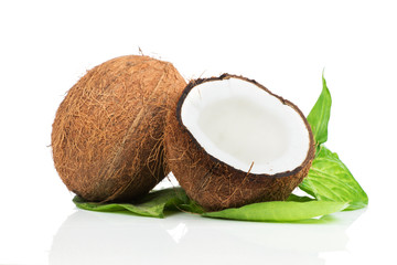 Coconuts with green leaves on white background