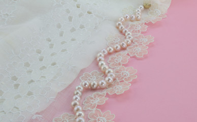 Pearl necklace on vintage silk gauze lace