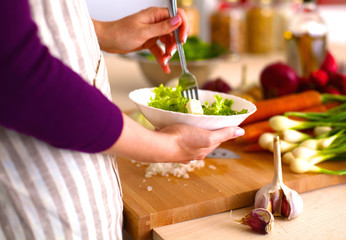 Young Woman Cooking in the kitchen. Healthy Food