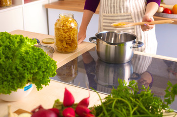 Young Woman Cooking in the kitchen. Healthy Food