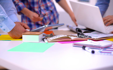 Close-up of three young creative designers working on project together. Team work