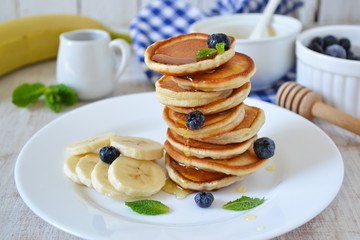Pancakes for breakfast with honey and blueberries
