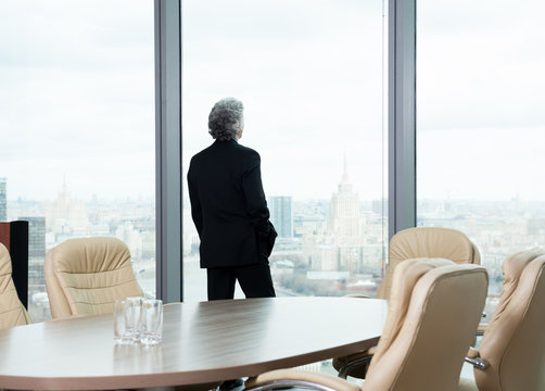 Middle Age Businessman Looking Out The Window