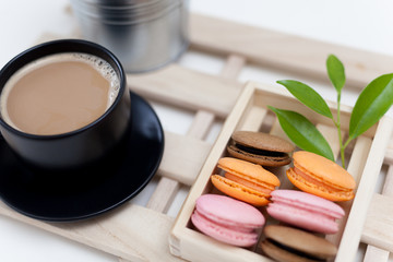 Coffee with dessert, colored macaroons