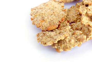 Wheat flakes on a white background.