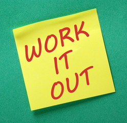 The words Work It Out in red text on a yellow sticky note posted on a green background as a reminder to sit down and discuss problems