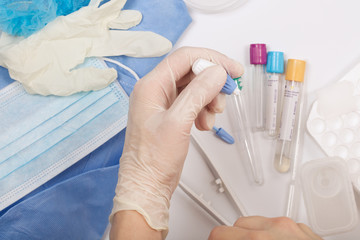 Lab technician applies a fingerstick before taking blood analysi