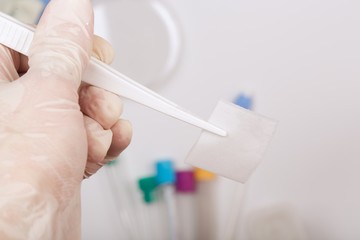 Alcohol wipe in the hand of a lab technician