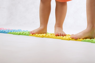 Childrens feet on a orthopaedic mat