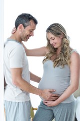 Fototapeta premium Man holding pregnant womans stomach