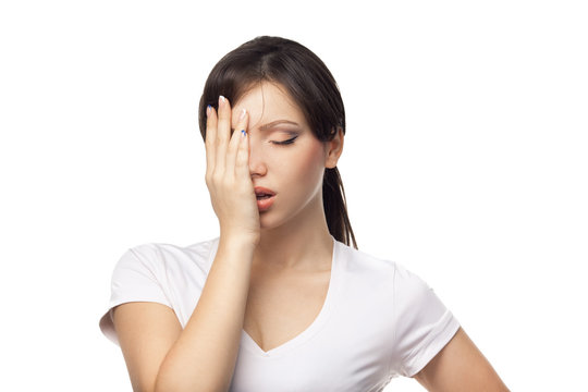 Close-up Of A Tired Young Woman Over White Background