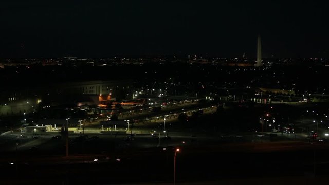 Fast motion of the Pentagon cityscape with busy highway at night in Washington DC, USA.