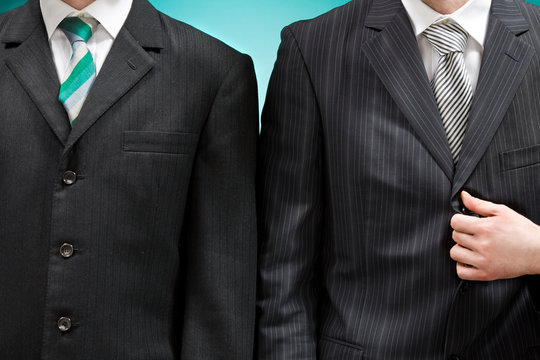 two businessman detail with necktie and suit isolated on blue