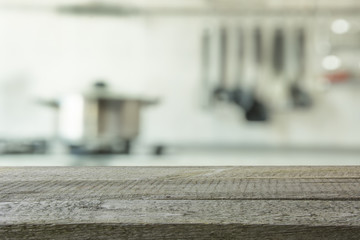 Blurred background. Modern kitchen with tabletop and space for you.