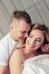 Obraz na płótnie Canvas Happy couple in a bedroom.