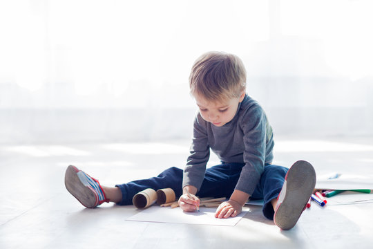 little boy draws