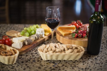 Wine bottle with a glass and a buch of food