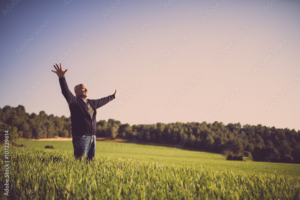 Wall mural old man happy in the field