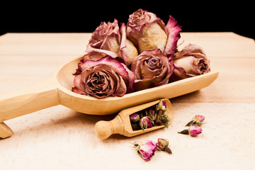  Dried roses and buds with wooden texture 