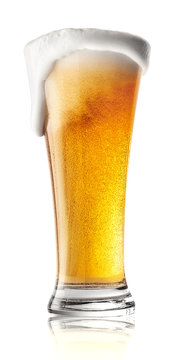 Tall Glass Of Beer With Foam Spilling
