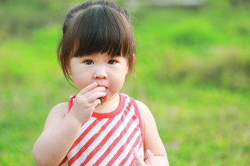 Little girl eating strawberries