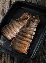 Grilled pork ribs on a dark pan
