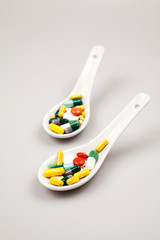 Composition with colorful pills and light grey background