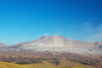 View of Mt. Aso that is spewing smoke at Autumn