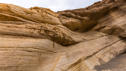 The textured striations of marble. Smooth, polished marble walls enclose the trail as it follows the canyon's sinuous curves. Mosaic Canyon, Death Valley National Park, California
