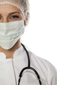 A Young Woman Doctor With A Mask And Cap