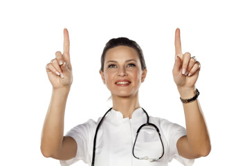 a young woman doctor touches empty screen