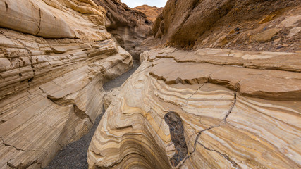 The textured striations of marble. Smooth, polished marble walls enclose the trail as it follows the canyon's sinuous curves. Mosaic Canyon, Death Valley National Park, California