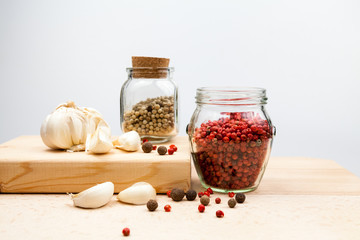 Garlic and spices on wooden kitchen board