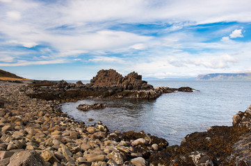North sea coast, scenic fjords and rocky beach on a cloudy summer day, Iceland