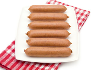 Uncooked Hotdogs on a Plate