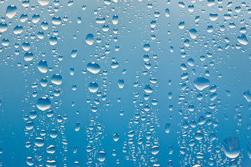 condensation drops on glass with blue backgroung