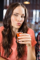 Woman looking at camera with shot in hand © WavebreakmediaMicro